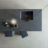 a Dekton Micron kitchen island and grey cement floor
