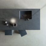 a Dekton Micron kitchen island and grey cement floor