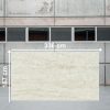 Losa grande de Dekton Nara de 336x167 cm en almacén industrial, con textura beige.
