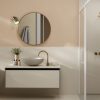 año moderno con encimera Neolith Creme, lavabo blanco, grifo dorado y espejo redondo, resistente al agua para hogares en Málaga