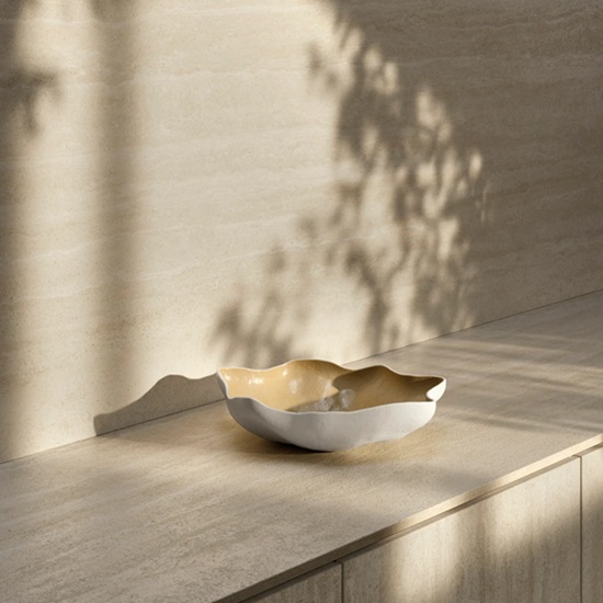 Detalle de encimera Sapienstone Travessa con bol decorativo y juego de luces y sombras