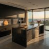 Isla de cocina en porcelánico Techlam Pierre Bleue negro con vistas al mar al atardecer