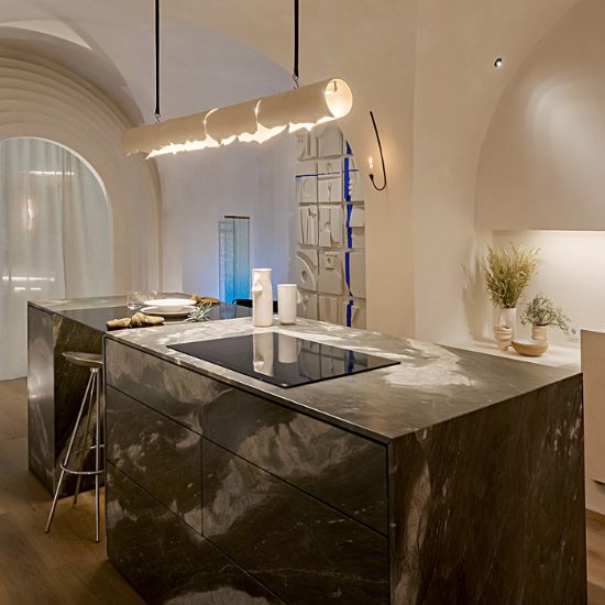 Isla de cocina con encimera cuarcita Terra Alisia verde gris y luz colgante