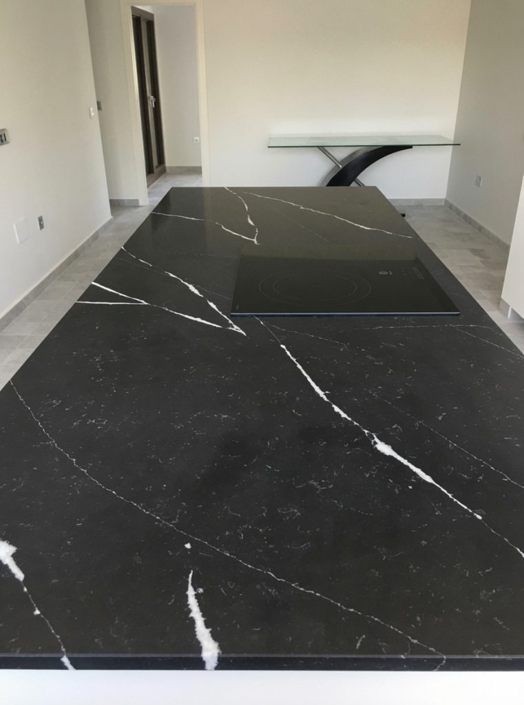 Equs Marquina black quartz kitchen island with white veins installed in Marbella