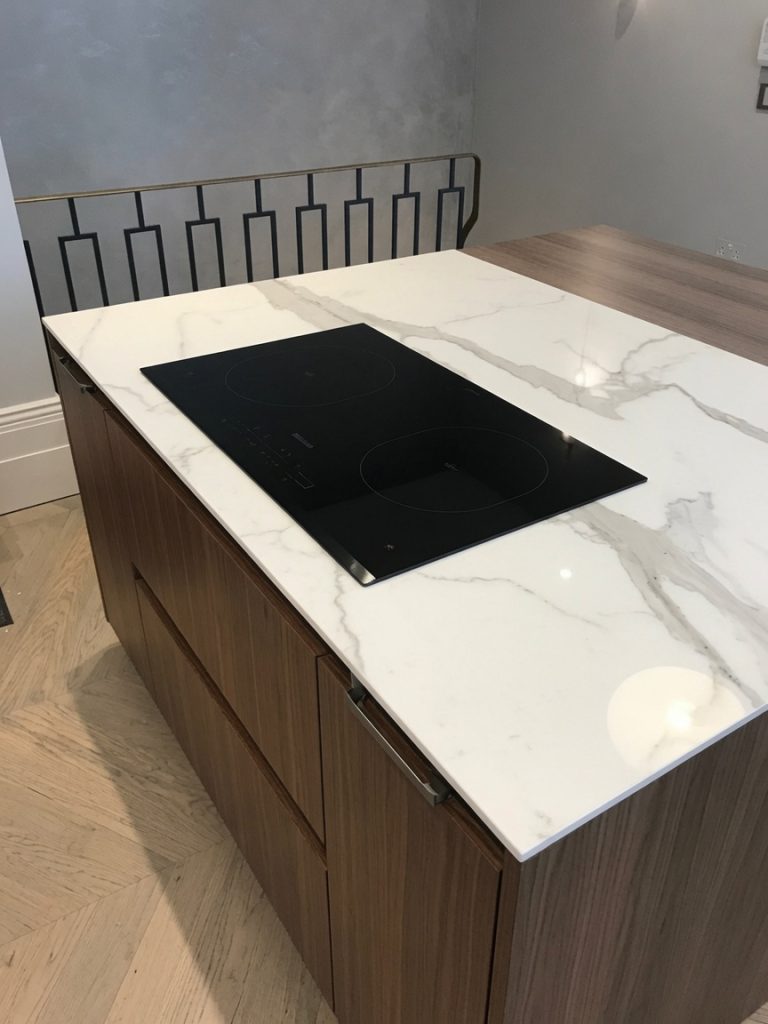 Neolith Estatuario white marble-effect kitchen island installed on the Costa del Sol