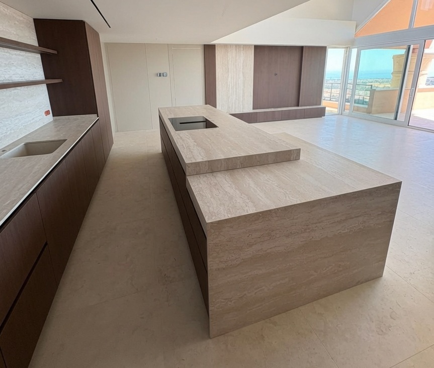  beige porcelain kitchen island with travertine effect installed in a Villa in Marbella