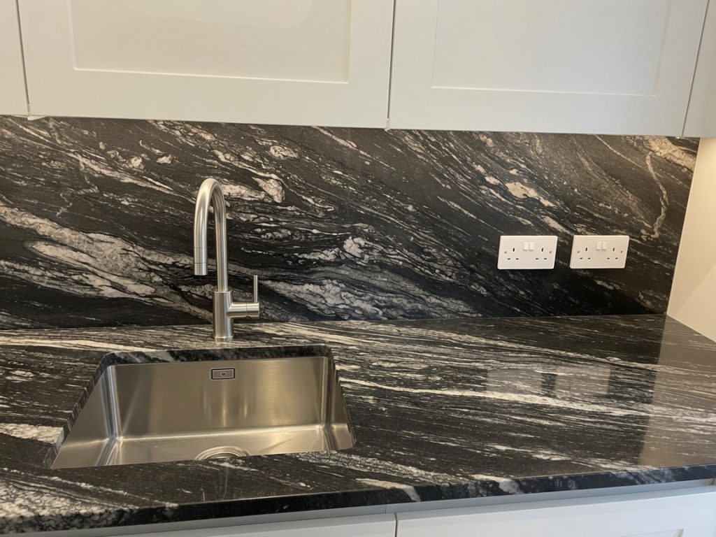 aturamia Cheyenne black granite worktops and splashback installed in a Marbella renovation